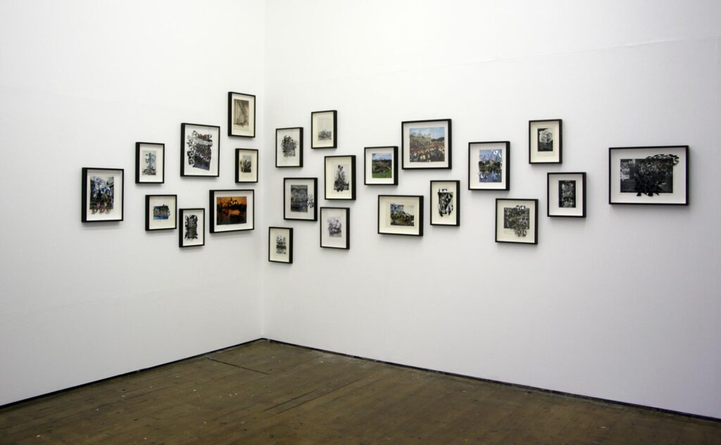 photographs framed and scattered on a corner wall